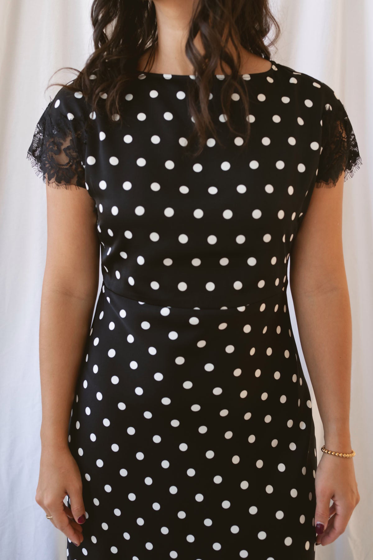 Joanna black polka dot midi dress featuring short sleeves and delicate lace trim detailing.