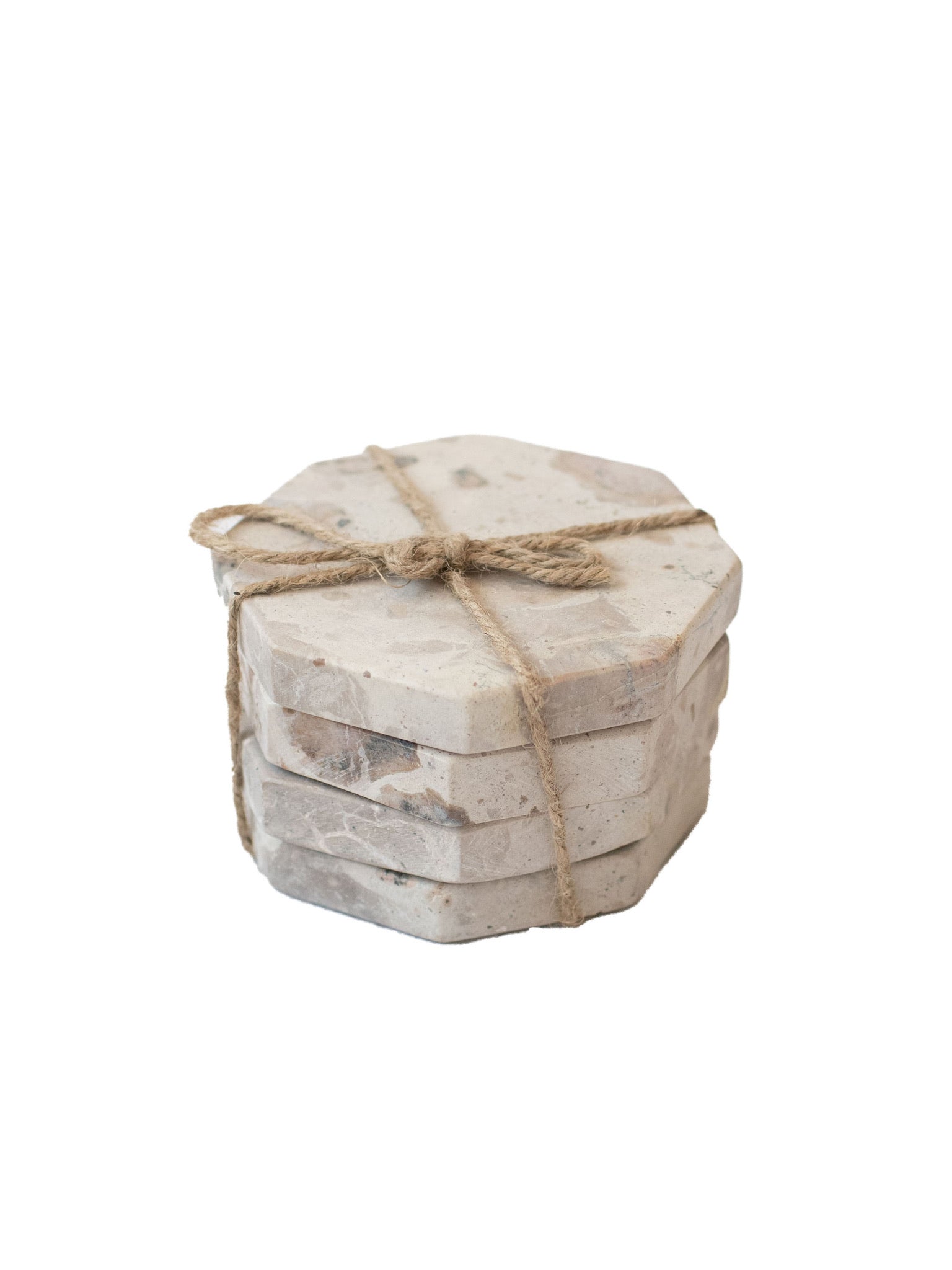 The stack of beige marble octagon coasters tied up with twine.