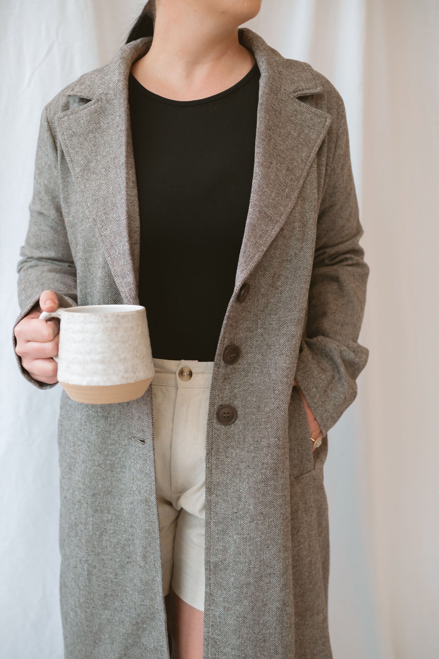 Model wearing the millie coat over an all black base. Lightweight and versatile.