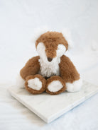 plush fox on marble tray with white background 