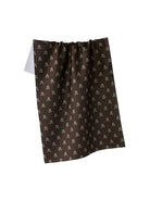 Brown Waffle kitchen towel with light flower details on white background 