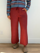 Model is wearing the butter soft drawstring waist cropped pants in merlot. 