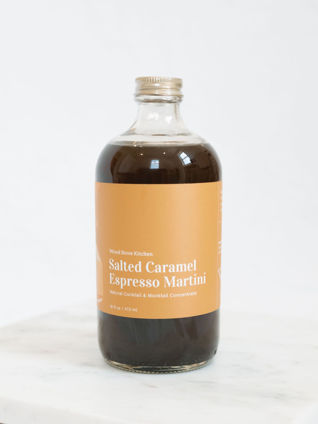 Salted caramel espresso martini mocktail and cocktail mix on a marble tray with white background 