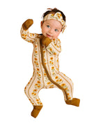 little baby wearing a bamboo sleeper with sunflower and mustard detail on a white background 