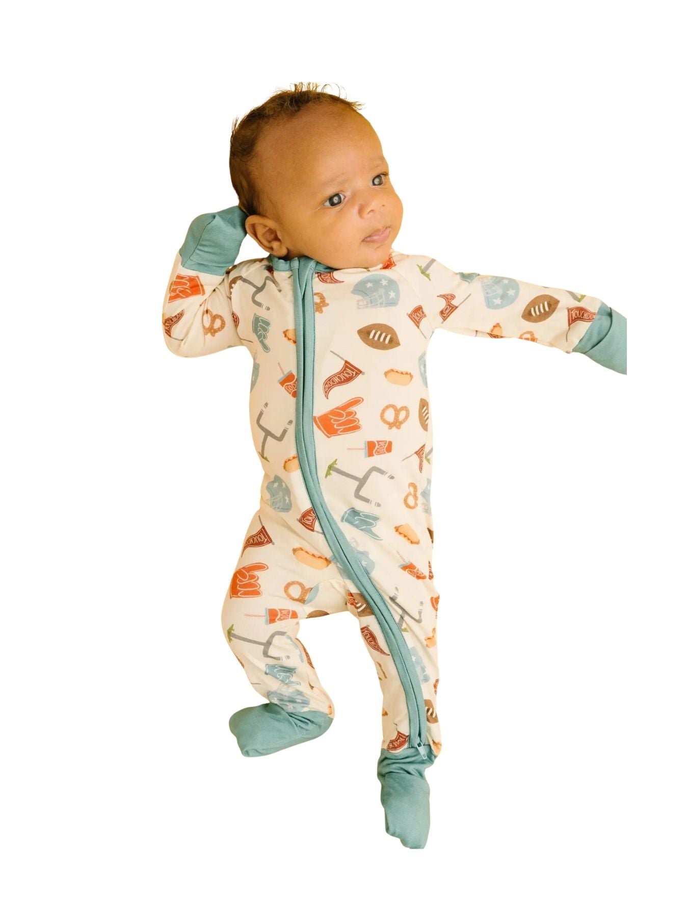Cream bamboo sleeper with football theme icons with baby on a white background