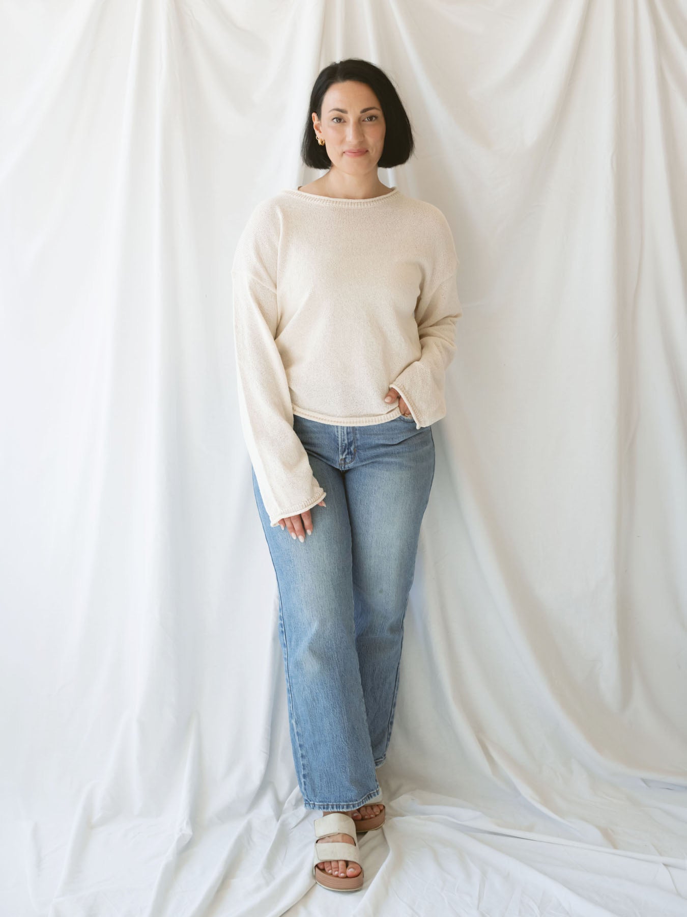 Model wearing raw edge detail sweater in oatmeal.