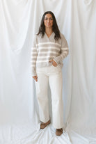 Carly light taupe striped knit sweater with a collared V-neckline and contrast trim.