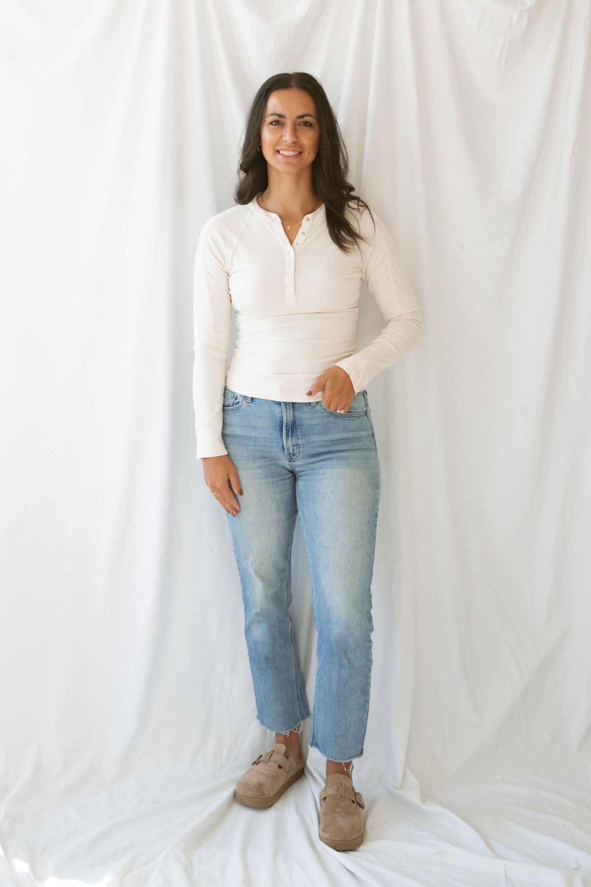 Model wearing the natural henley long sleeve top