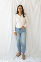 Model wearing the natural henley long sleeve top