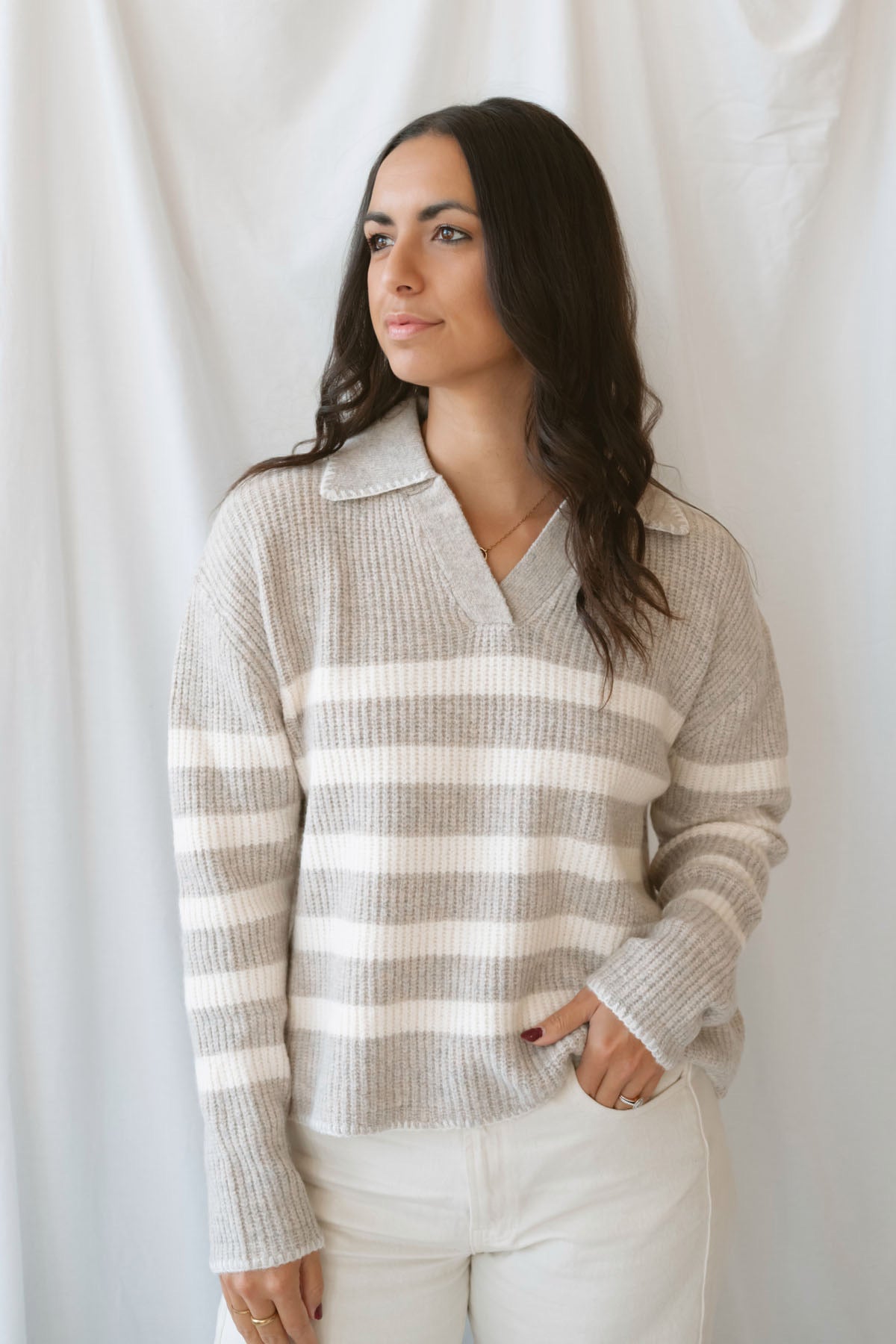 Carly light taupe striped knit sweater with a collared V-neckline and contrast trim.