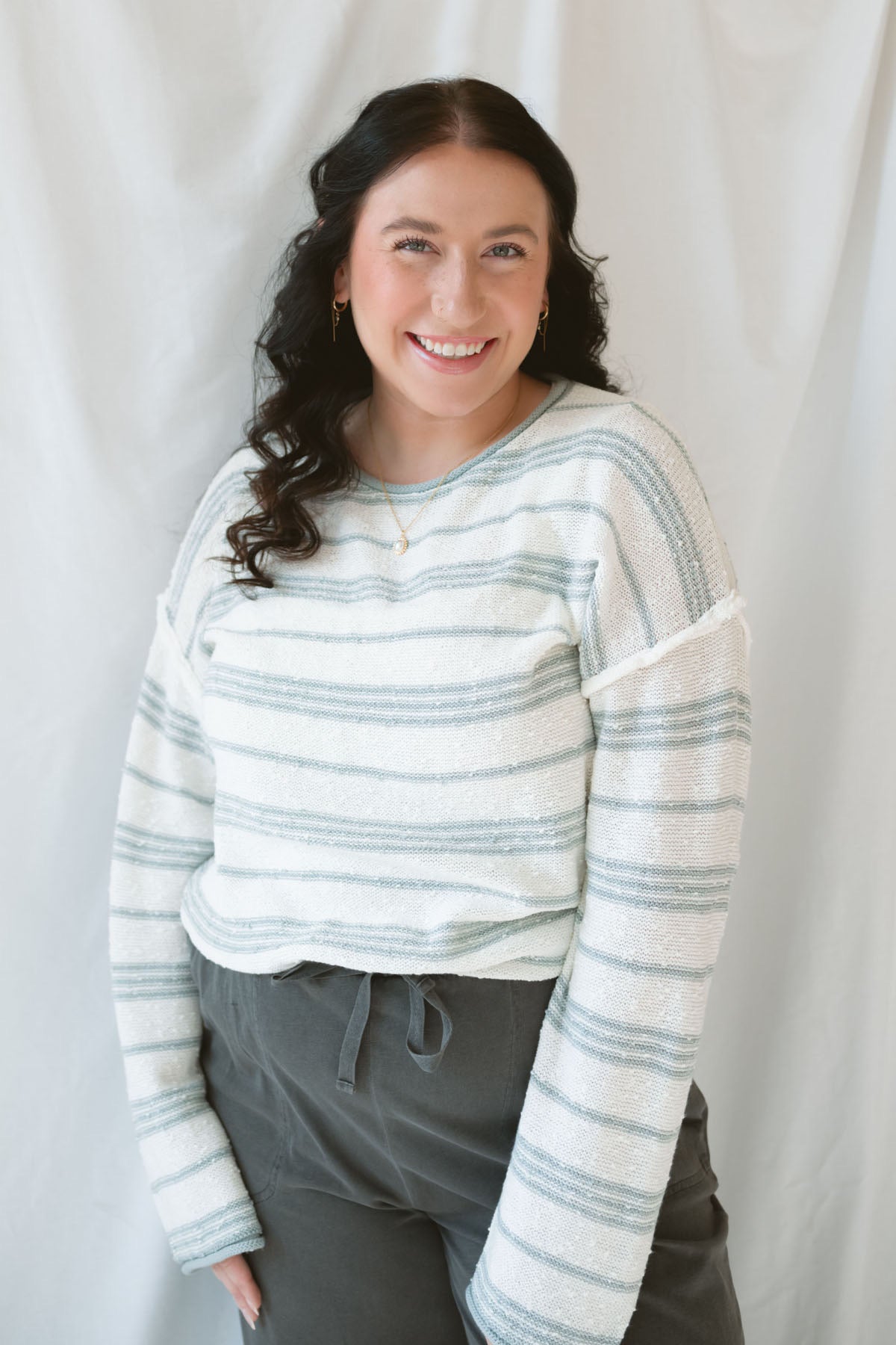 Model wearing the textured striped oversized sweater. Lightweight enough to wear now and into the next season. 