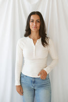 Model wearing the natural henley long sleeve top