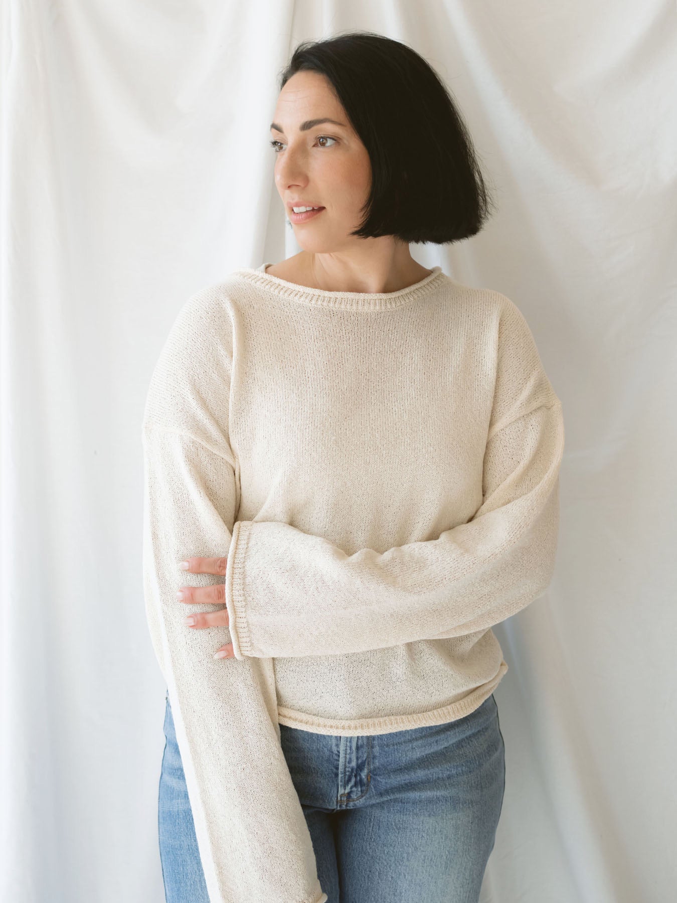 Model wearing raw edge detail sweater in oatmeal.