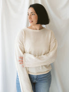 Model wearing raw edge detail sweater in oatmeal.