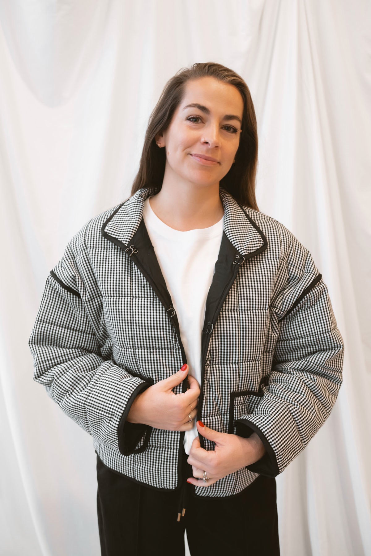 Black gingham quilted jacket for women featuring a classic checked pattern, textured quilted construction, and versatile everyday layering design.