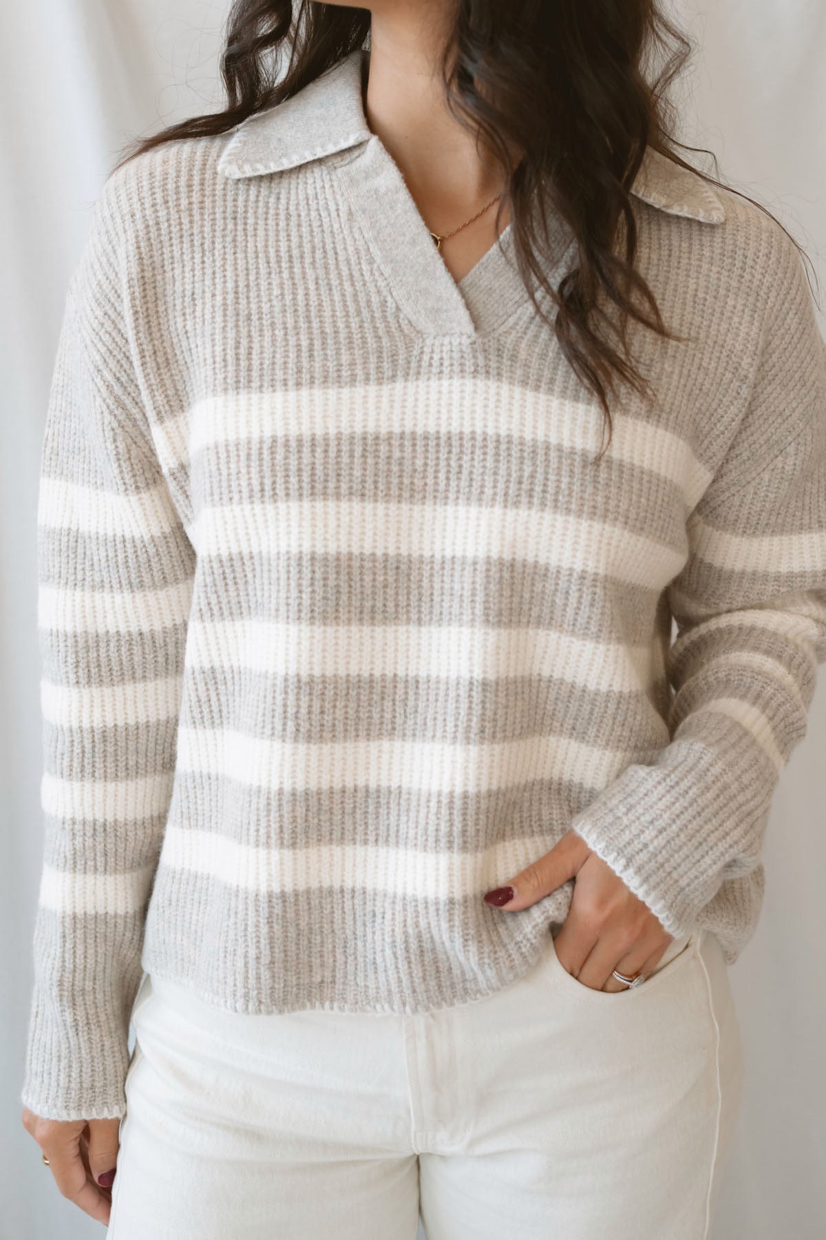 Carly light taupe striped knit sweater with a collared V-neckline and contrast trim.