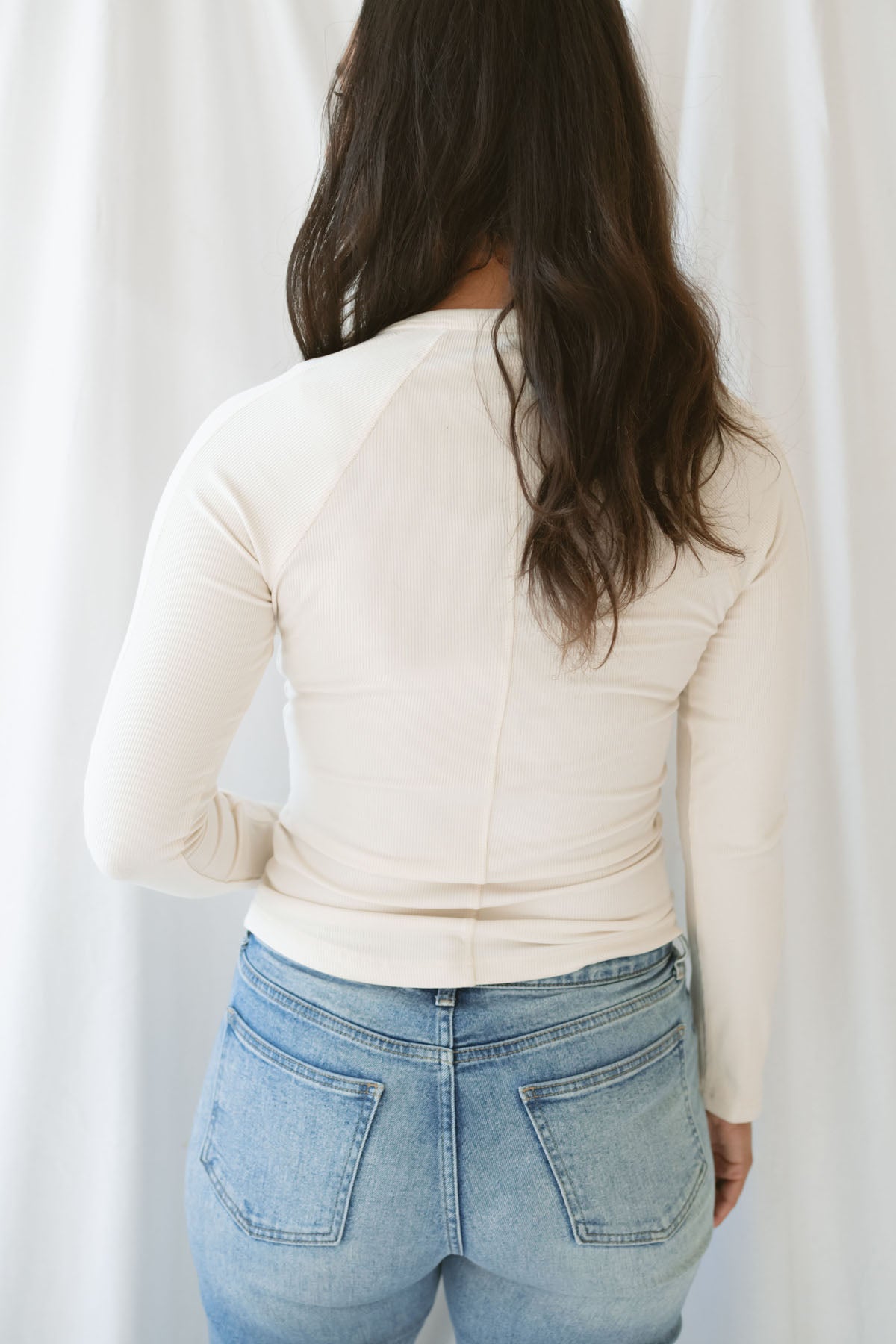 Model wearing the natural henley long sleeve top