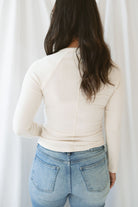 Model wearing the natural henley long sleeve top