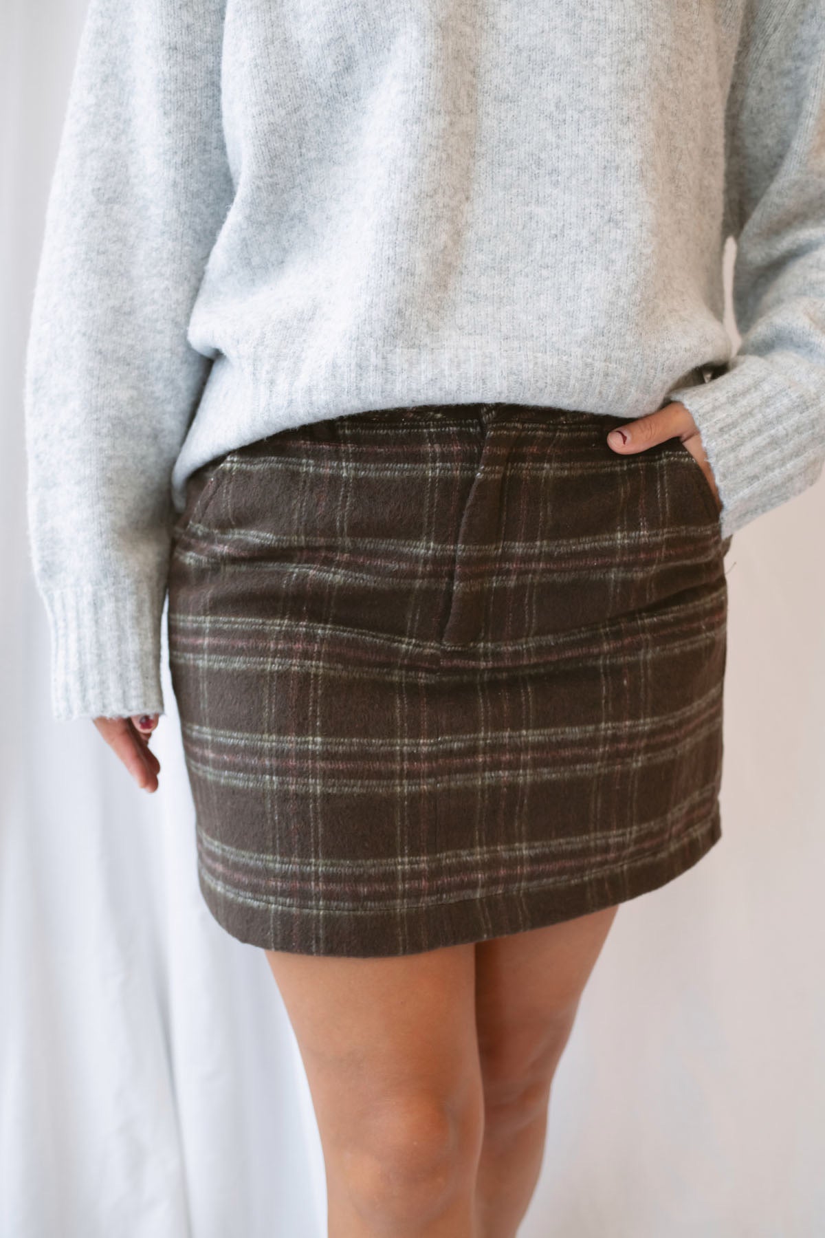 Kendra Brushed Plaid Mini Skirt in chocolate brown and olive featuring a classic plaid pattern and soft brushed texture.
