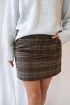 Kendra Brushed Plaid Mini Skirt in chocolate brown and olive featuring a classic plaid pattern and soft brushed texture.
