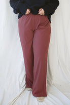 Jordan Finish Line women's track pants in Rosewood, featuring a muted earthy pink color and sporty casual silhouette for relaxed everyday outfits.