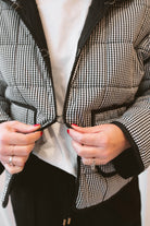 Black gingham quilted jacket for women featuring a classic checked pattern, textured quilted construction, and versatile everyday layering design.