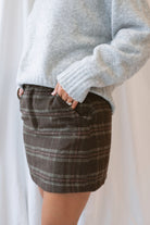 Kendra Brushed Plaid Mini Skirt in chocolate brown and olive featuring a classic plaid pattern and soft brushed texture.
