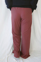 Jordan Finish Line women's track pants in Rosewood, featuring a muted earthy pink color and sporty casual silhouette for relaxed everyday outfits.