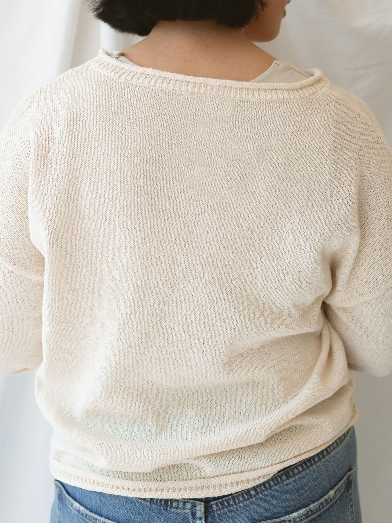 Model wearing raw edge detail sweater in oatmeal.