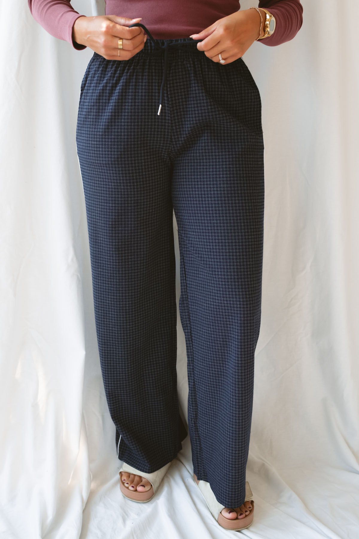 Model wearing the drawstring check pants in navy. Easy to pair a variety of basic tops with now and into seasons ahead. 