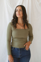Model wearing the square neck long sleeve ruched side top in olive.
