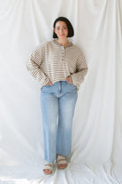 Model wearing the Quinn henley striped long sleeve sweater. 