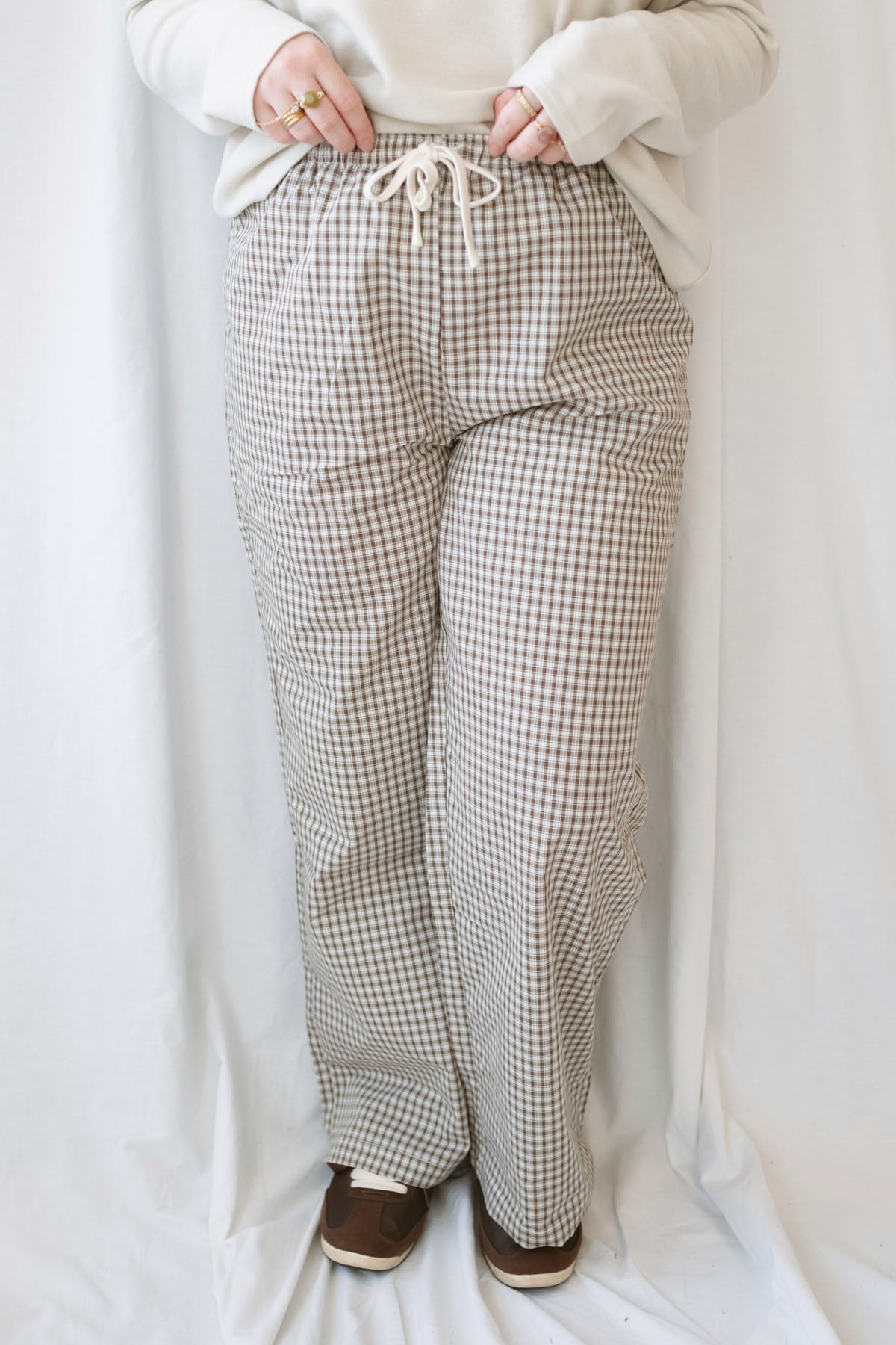 Avery brown and off-white checkered loose fit pants with an adjustable tie-front waist.