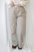 Avery brown and off-white checkered loose fit pants with an adjustable tie-front waist.