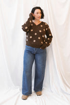 Dark wash stretch barrel-leg jeans for women featuring a subtle curved leg silhouette, twisted seam detailing, and a modern relaxed denim design.