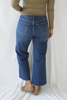 Model wearing the scissor cut slim denim in a dark wash. Great length to wear with a pointed toe boot or sneaker. Can easily be dressed up or down. 