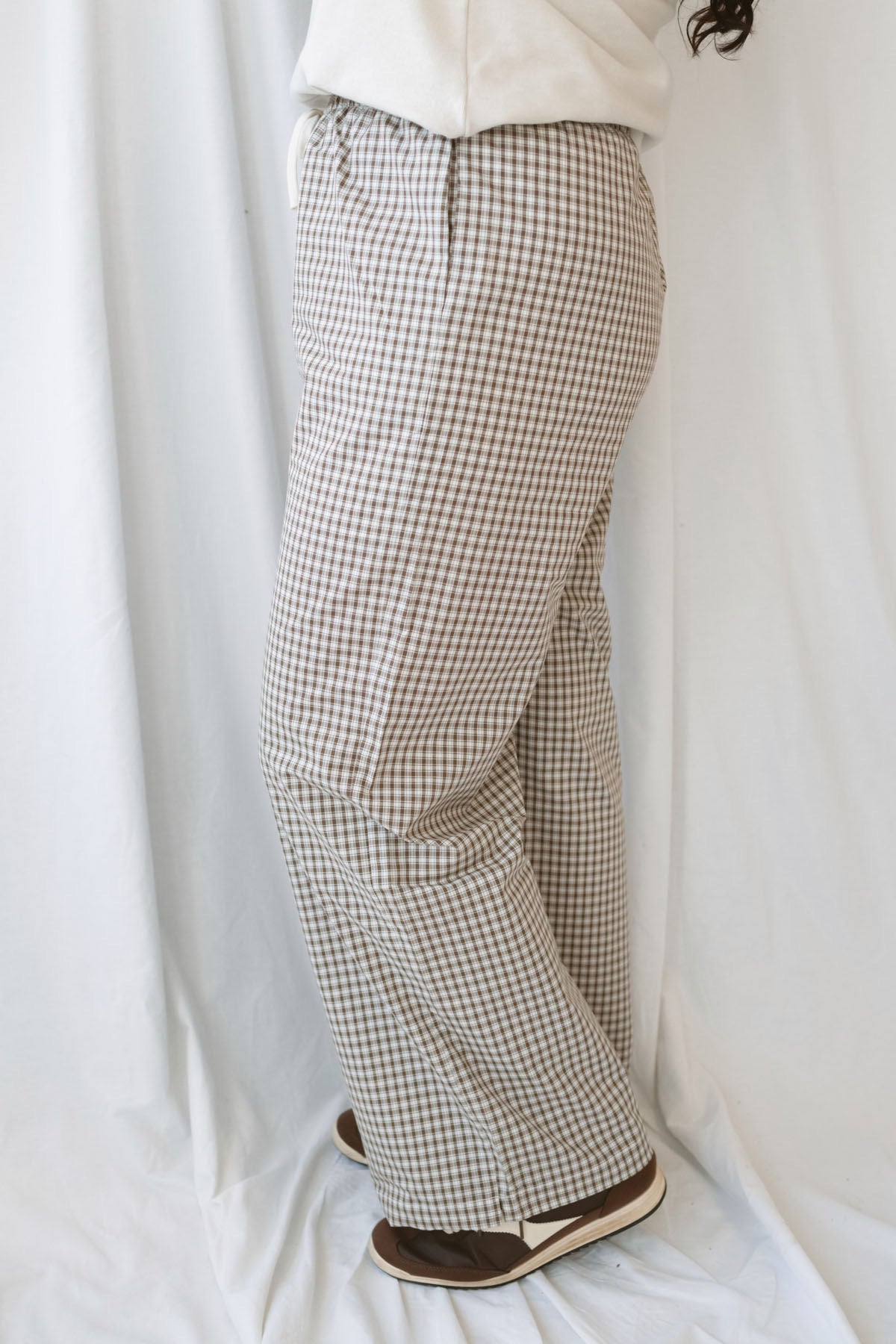 Avery brown and off-white checkered loose fit pants with an adjustable tie-front waist.
