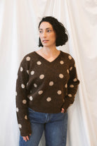 Chocolate brown long-sleeve V-neck knit sweater for women featuring contrasting polka dot detailing and a classic feminine silhouette for fall and winter styling.