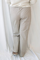 Avery brown and off-white checkered loose fit pants with an adjustable tie-front waist.