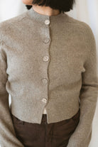 Donna women's Taupe sweater cardigan featuring a classic round neckline, long sleeves, and neutral knit texture for casual everyday layering.