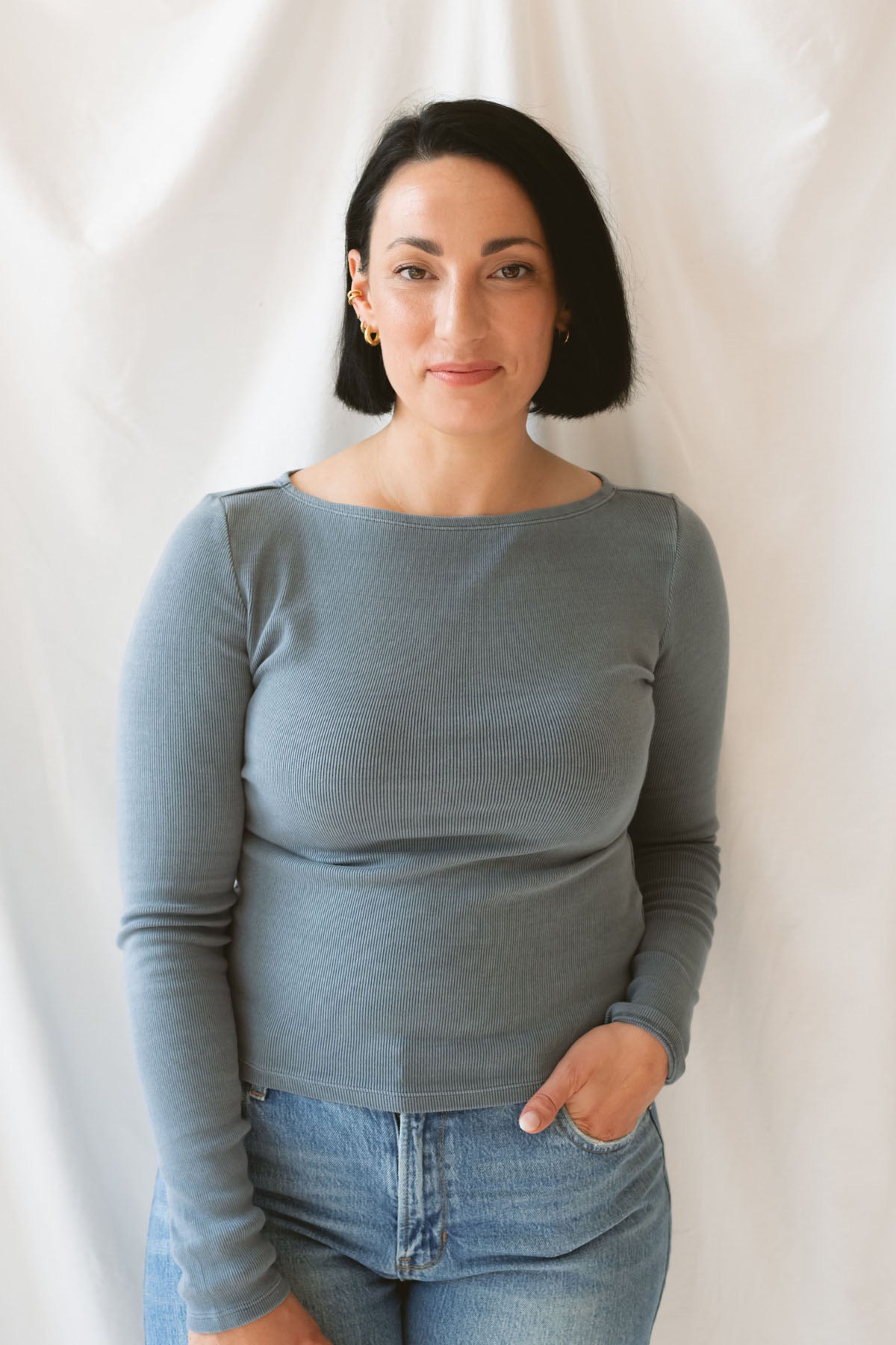 Model wearing ribbed long sleeve boat neck top. Paired with a basic denim pant, but can be styled in a variety of ways. 