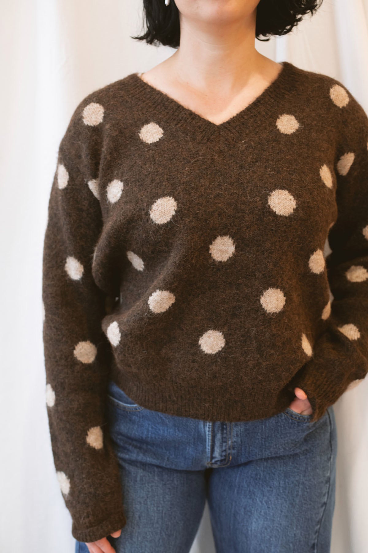 Chocolate brown long-sleeve V-neck knit sweater for women featuring contrasting polka dot detailing and a classic feminine silhouette for fall and winter styling.