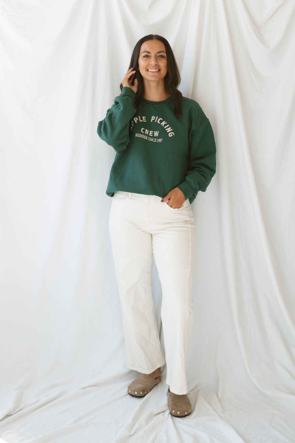 Model is wearing the apple picking sweatshirt in green.