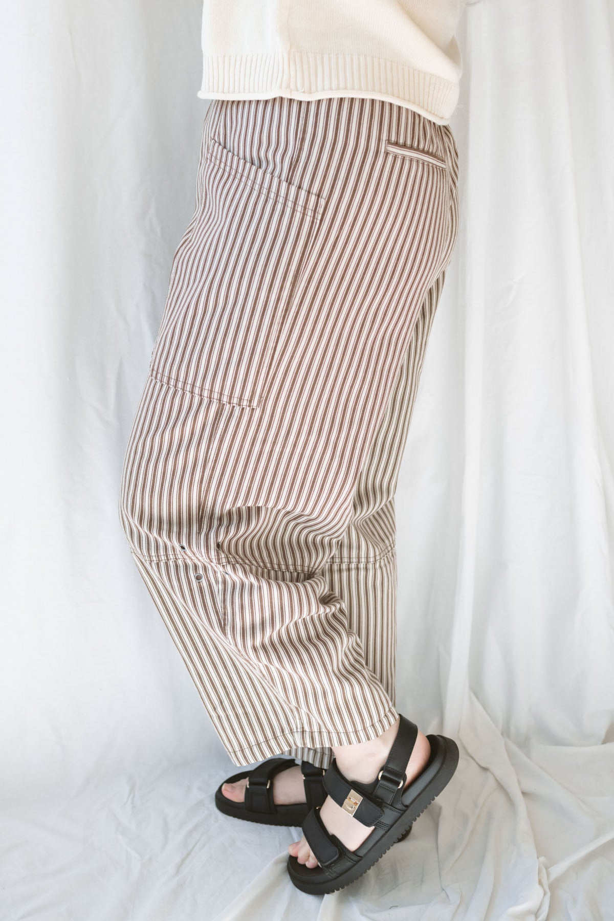 Model wearing the stripe pocket detail wide leg pants. 