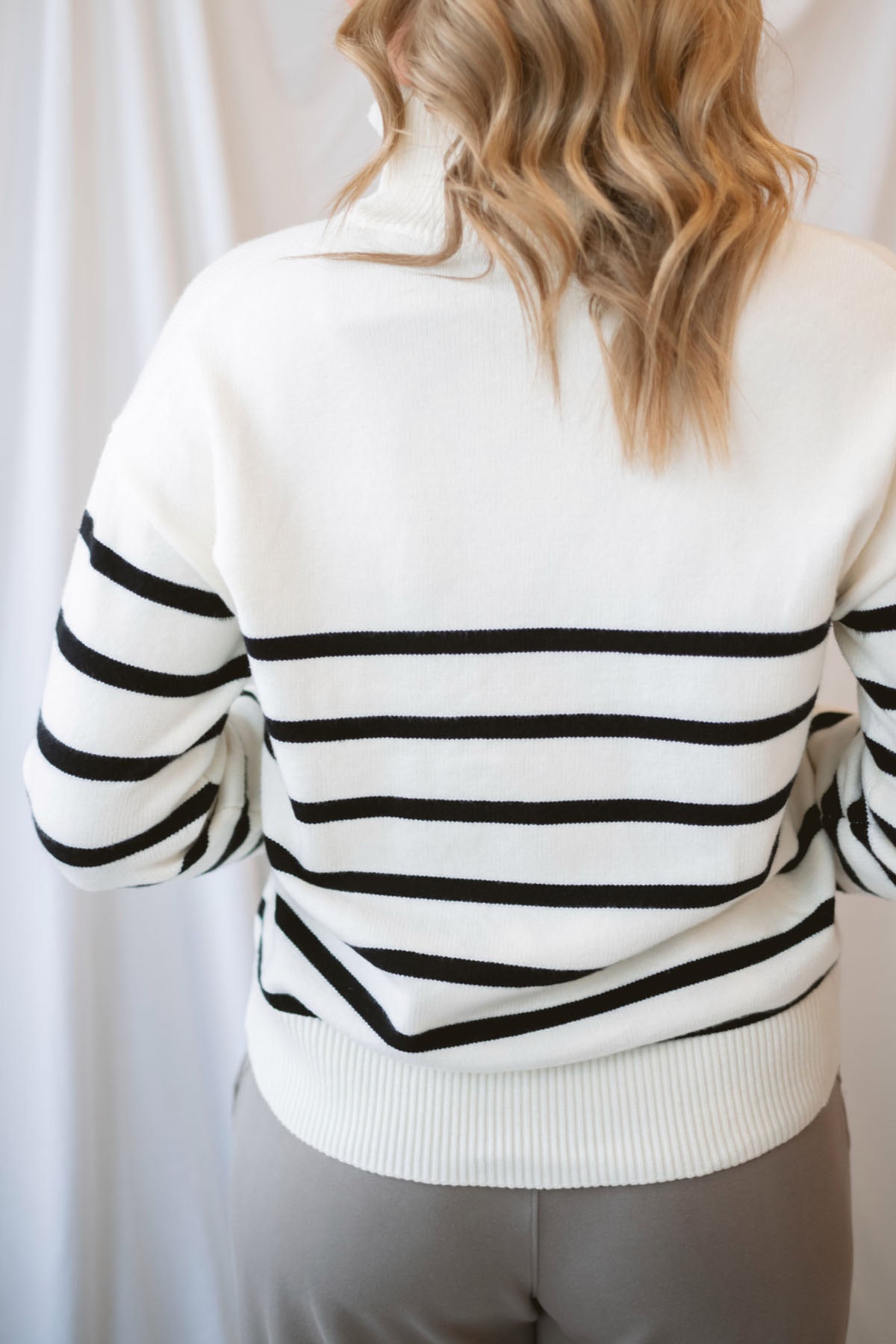 Maggie Striped Half Zip Mock Neck Knit Sweater Top in Cream and Black featuring a striped pattern and half-zip neckline.