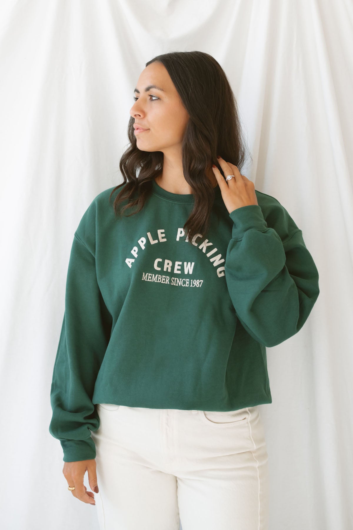 Model is wearing the apple picking sweatshirt in green.