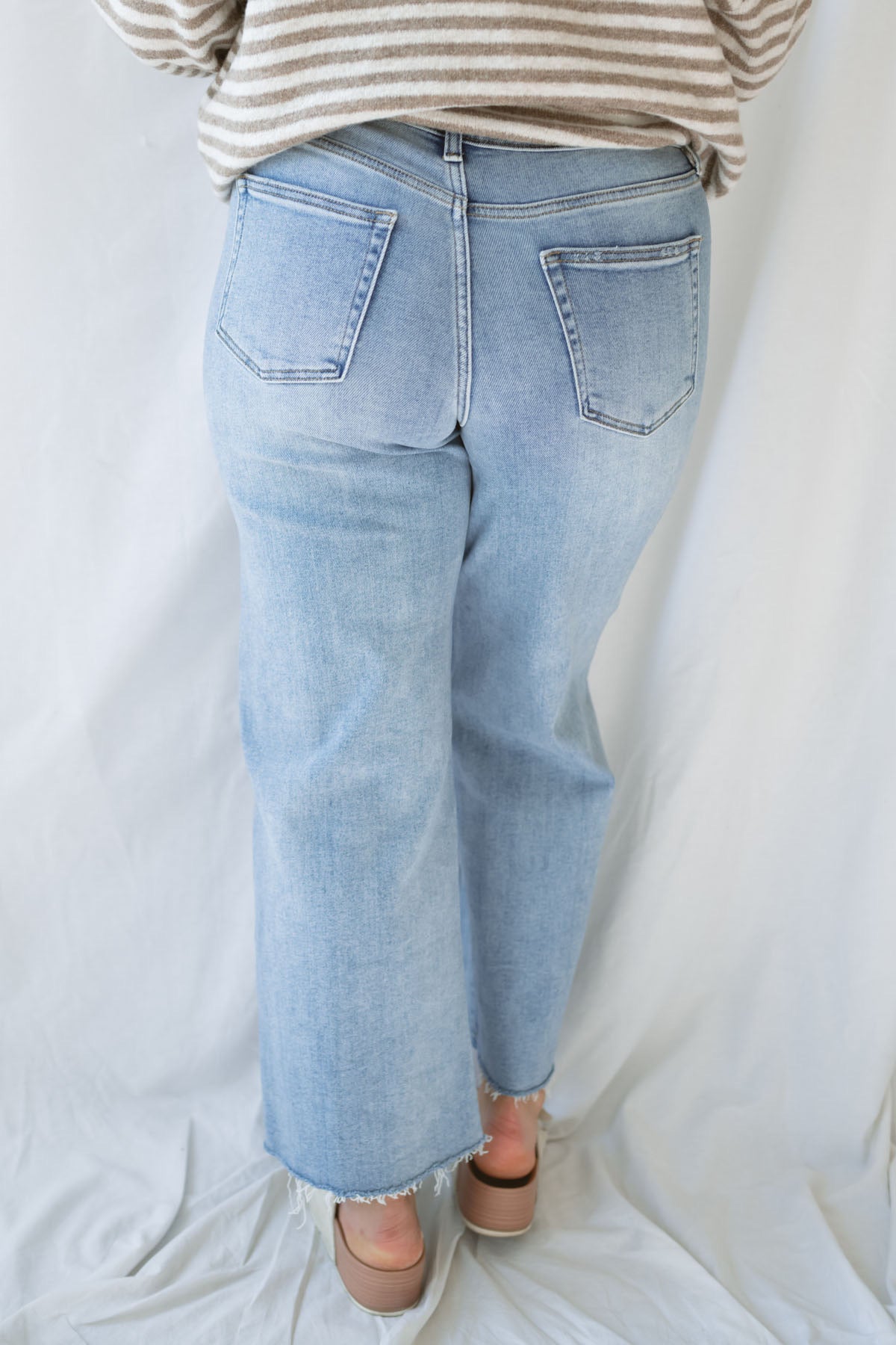 Back  view of model wearing the Piper medium wash denim.