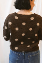 Chocolate brown long-sleeve V-neck knit sweater for women featuring contrasting polka dot detailing and a classic feminine silhouette for fall and winter styling.