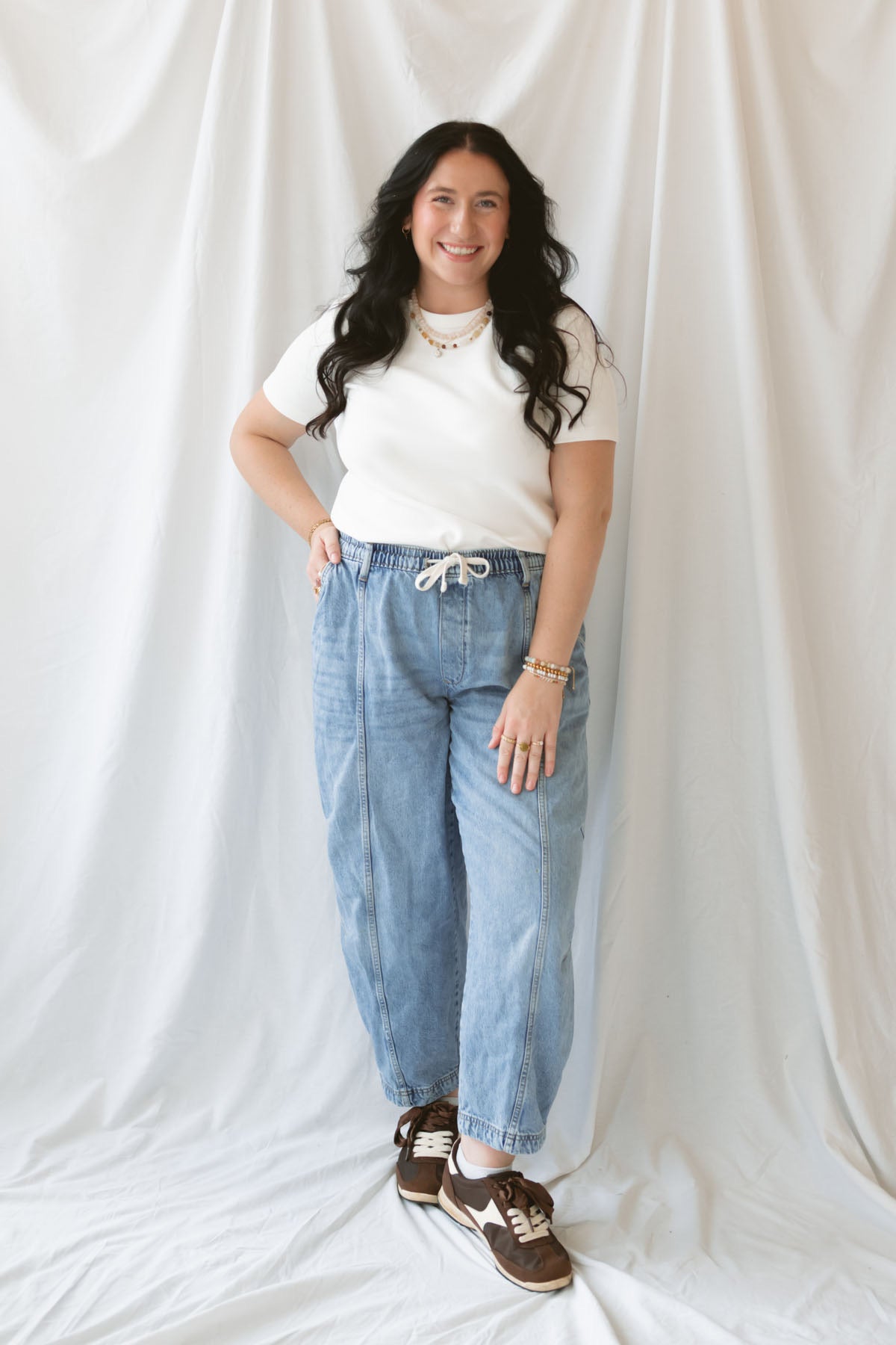 Model wearing round neck short sleeve top.