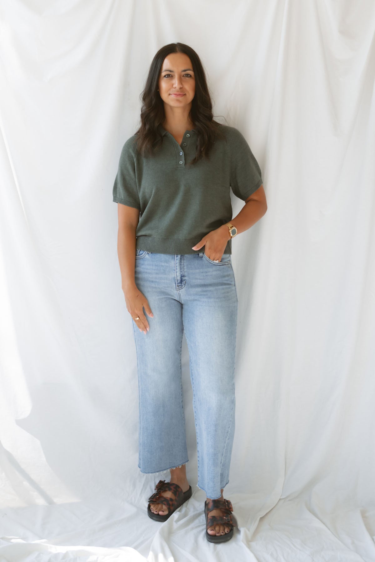 Model wearing the short sleeve polo sweater. A soft and polished option for a put together outfit. 